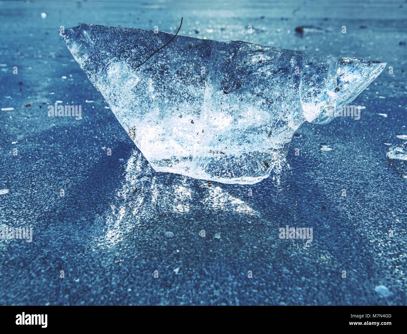 Clear ice on lake against to sky. Crystally clean piece of ice