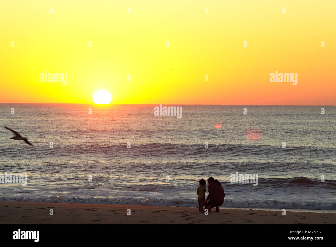 People watching sunrise on Atlantic Ocean Stock Photo - Alamy