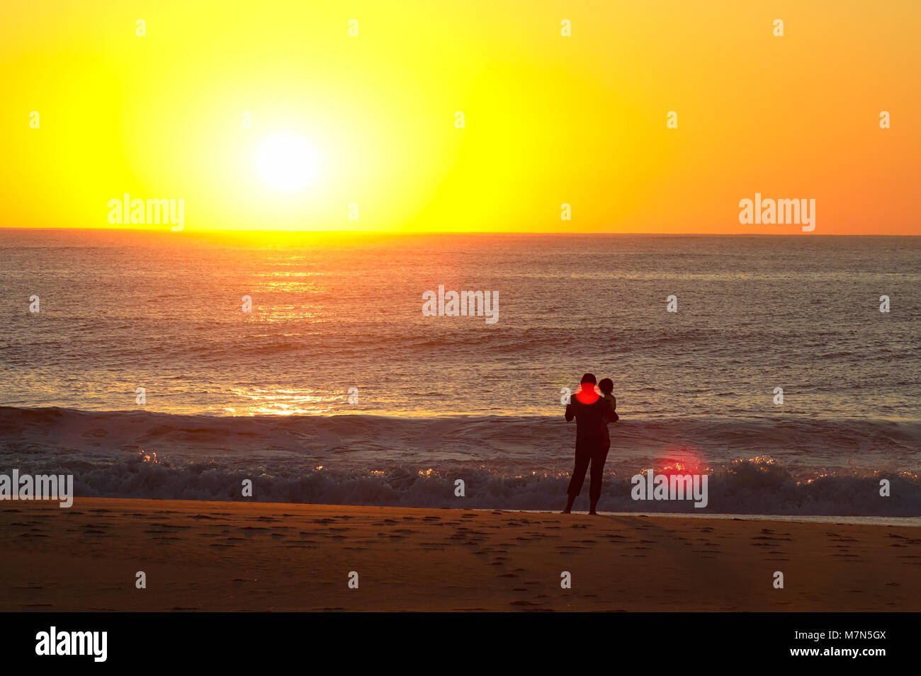 People watching sunrise on Atlantic Ocean Stock Photo - Alamy
