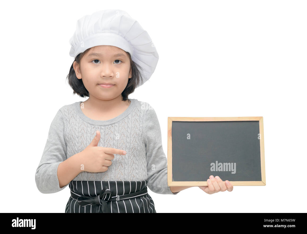 Little asian girl chef in uniform cook holding blackboard for in put text or menu, isolated on white background Stock Photo
