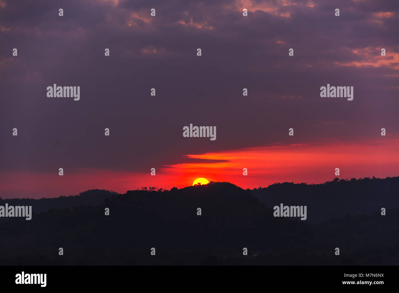 sunset over mountains or hills Stock Photo - Alamy