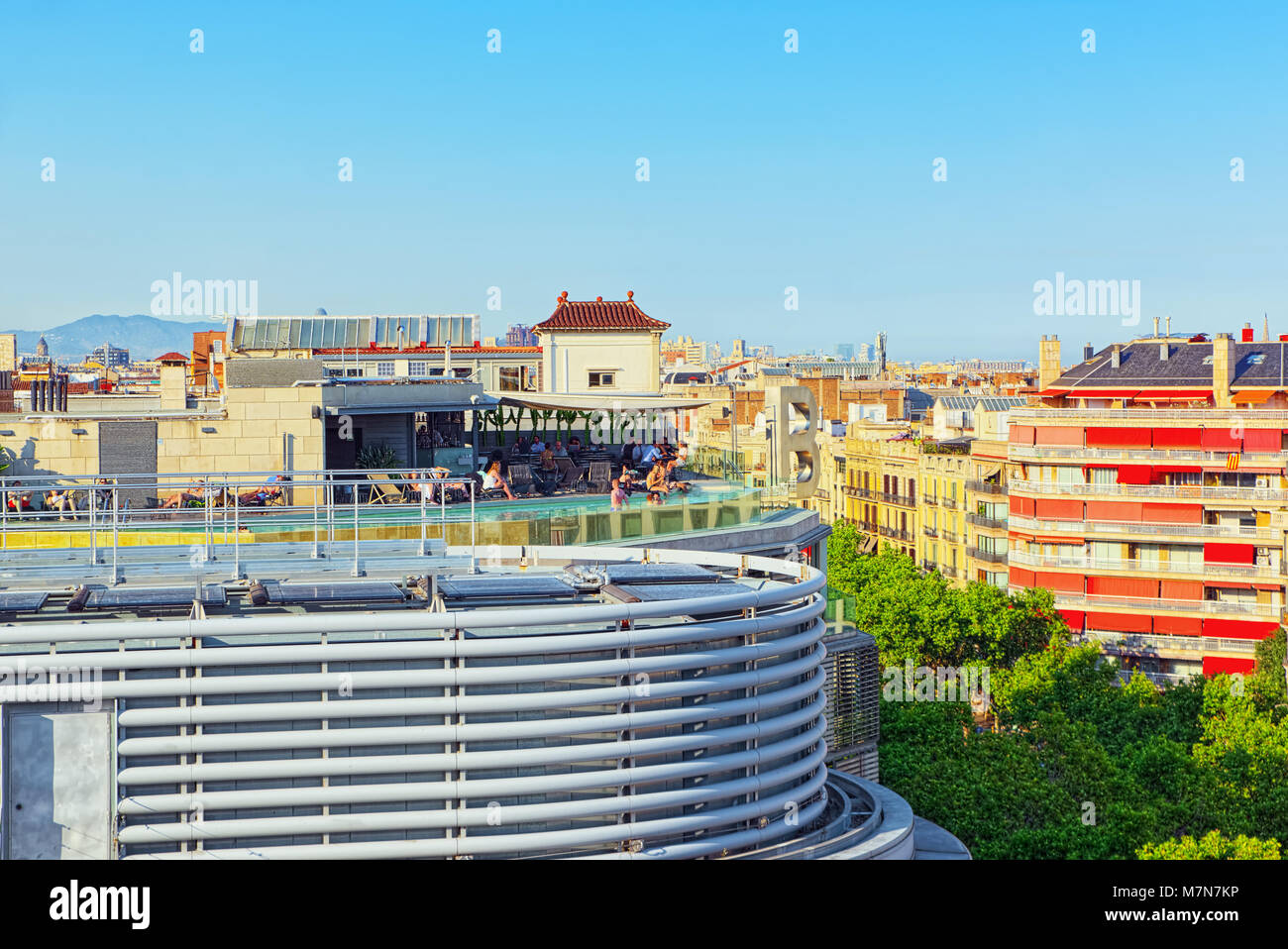 Barcelona, Spain - June 12, 2017 : Panorama on the urban center of Barcelona, the capital of the Autonomy of Catalonia. Pool on the roof with people. Stock Photo