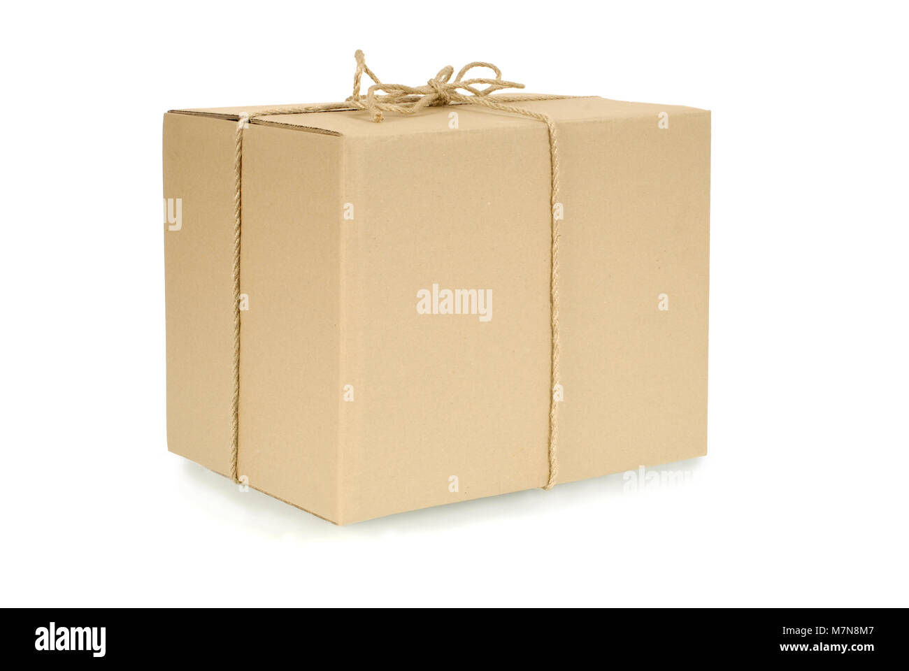 Plain brown blank cardboard box tied with rope or string and isolated on a  white background. Space for copy Stock Photo - Alamy