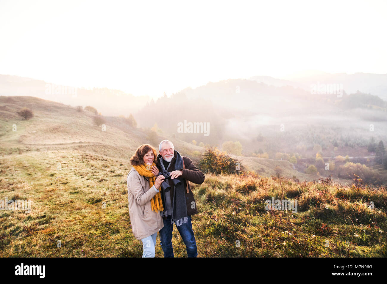 Senior couple on a walk in an autumn nature. Stock Photo