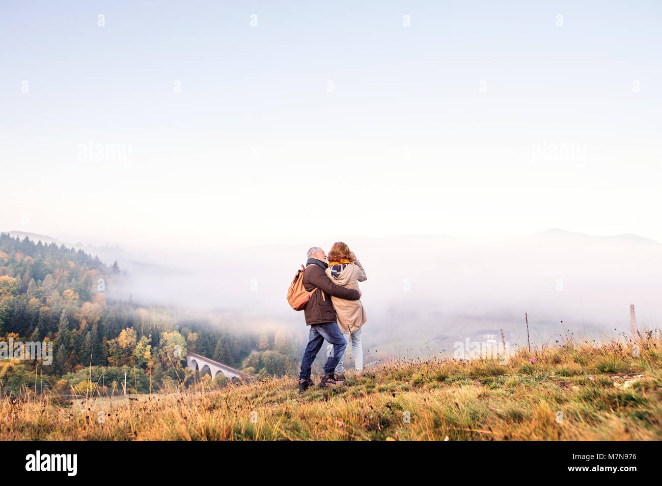 Senior couple on a walk in an autumn nature Stock Photo - Alamy