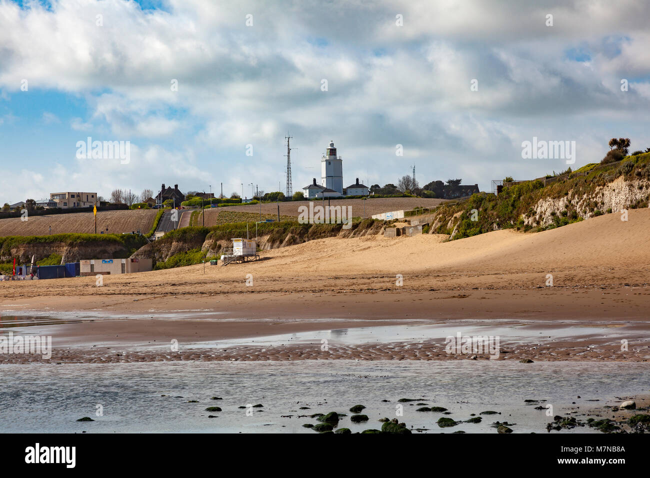 Joss Bay at low tide with North Foreland Lighthouse on the hill above, Broadstairs, Kent, UK