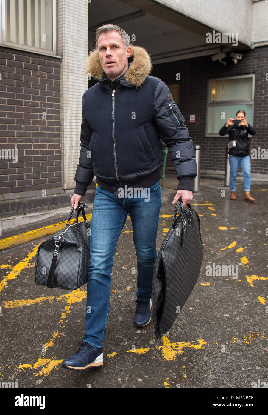 Jamie Carragher arrives at London Euston train station. Sky sports bosses  will speak to the pundit after he appeared to spit at a 14-year-old girl  after Manchester United beat Liverpool 2-1 at