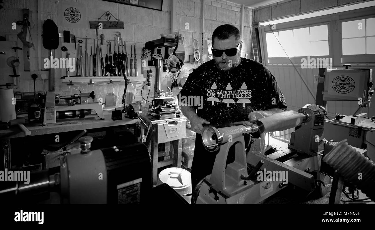 Chris Fisher, who has become known as the blind wood turner, in his workshop near Chorley. After his sudden loss of sight at just 39, he started using the internet to learn wood turning and is now an incredible craftsman with thousands of subscribers to his own YouTube channel. Stock Photo