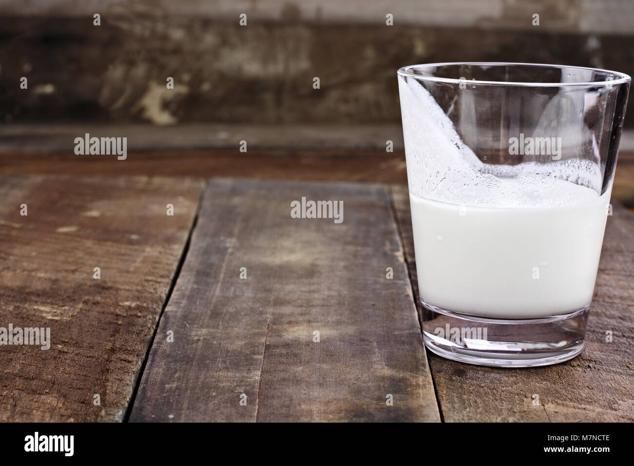 Kefir milk over rustic wooden background. Kefir is one of the top health foods available providing powerful probiotics. Stock Photo
