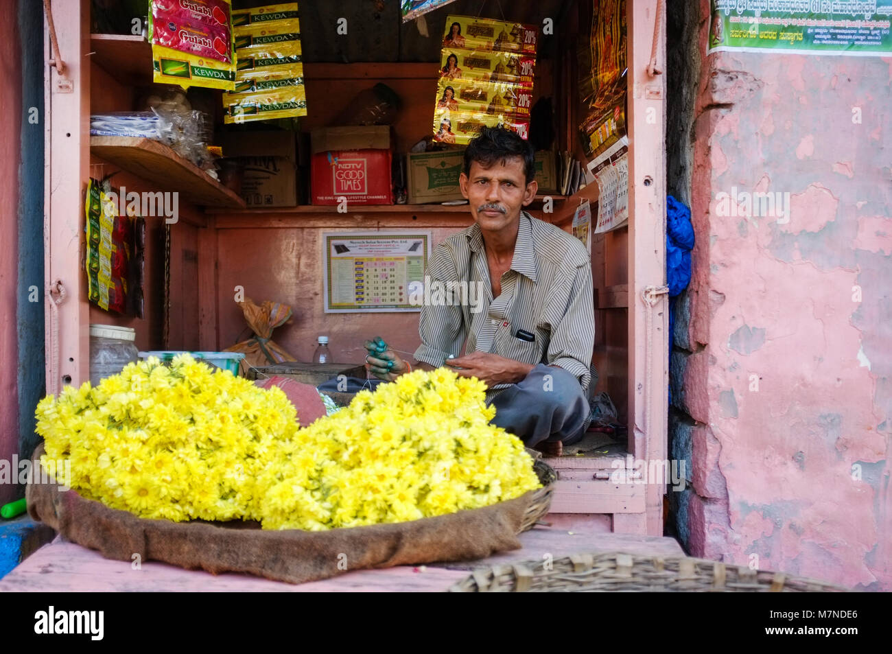 KAMALAPURAM, INDIA - FEBRUARY 2, 2015: Street vendor selling flowers for offerings at the temple. Stock Photo