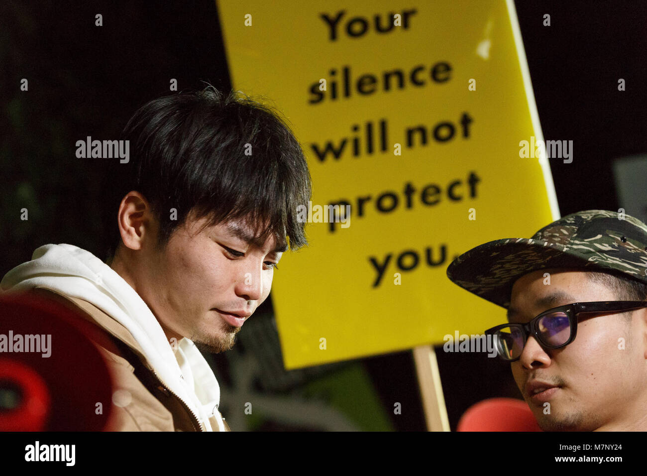 Aki Okuda (L), a former founding member of the Japanese students protest group Students Emergency Action for Liberal Democracy (SEALDs), attends a protest in front of the Prime Minister's Office after Japan's Finance Ministry admitted to altering records linking the Prime Minister's wife, Akie, to the Moritomo Gakuen scandal, March 12, 2018, Tokyo, Japan. It was revealed that Akie Abe's name was removed from documents detailing special treatment of Moritomo Gakuen. Prime Minister Shinzo Abe has constantly denied that neither he nor his wife had played a role in the sale of heavily discounted p Stock Photo