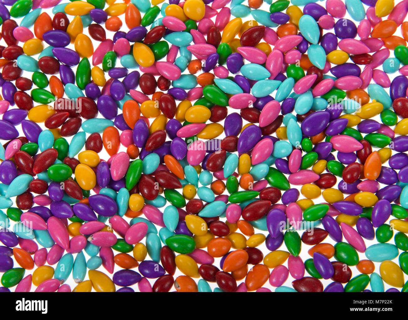 Background of candy coated sunflower seeds coated in smooth milk