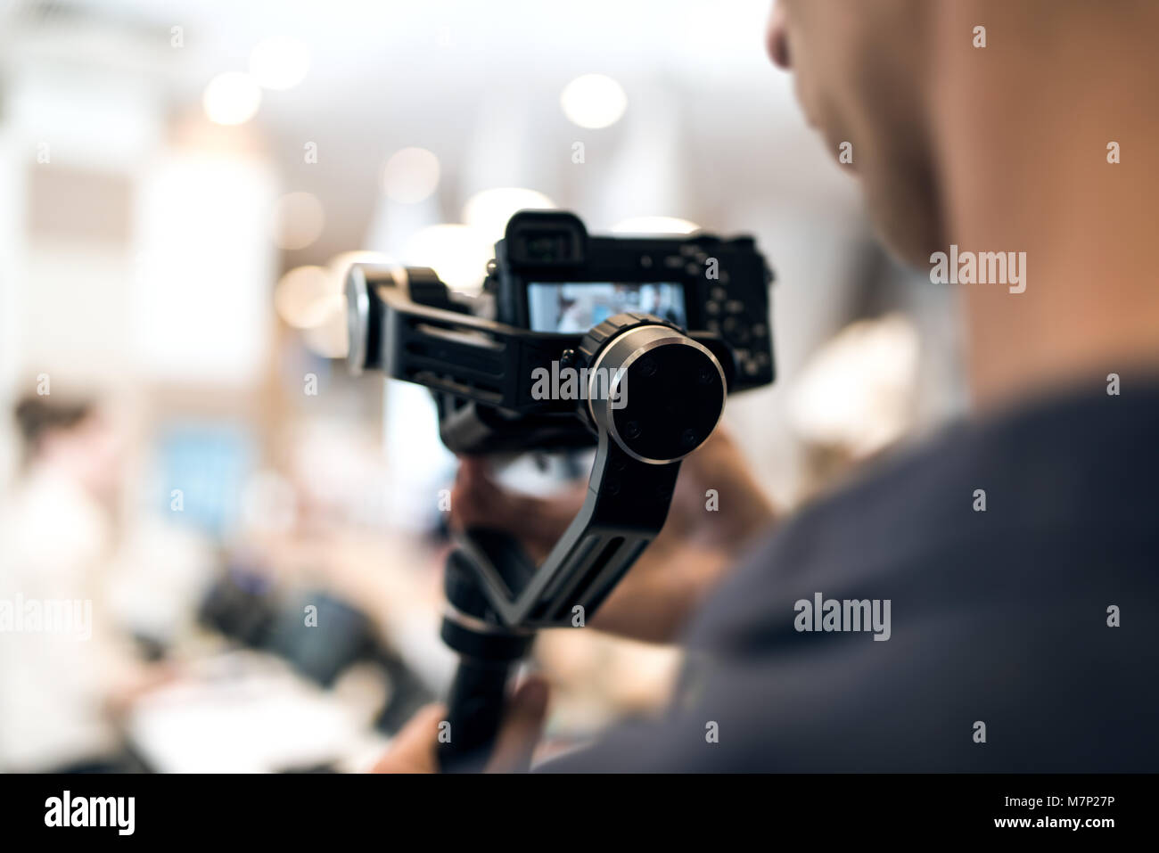 Adult professional videographer shooting using new steadycam. He