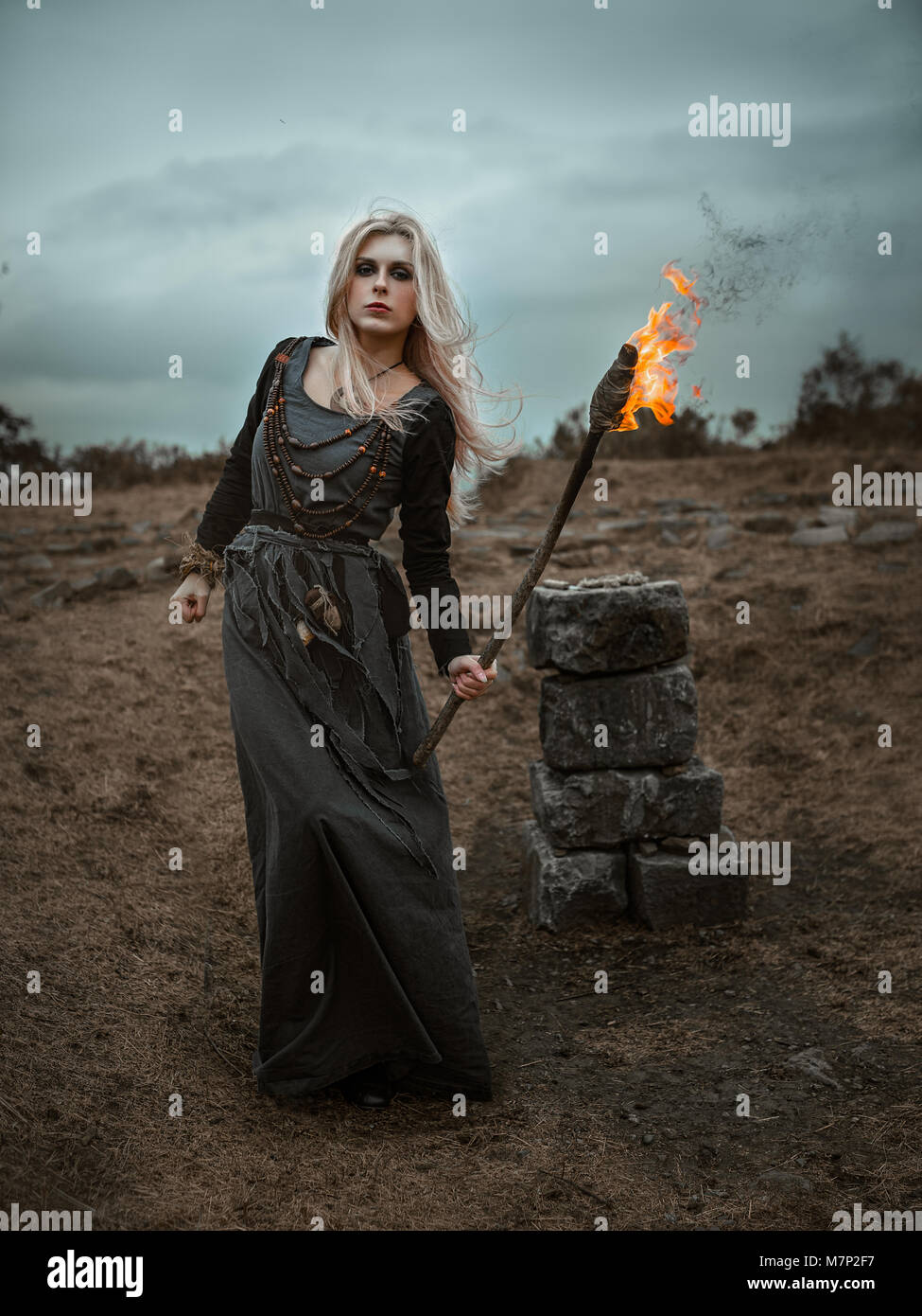 Witch in a long black dress Stock Photo