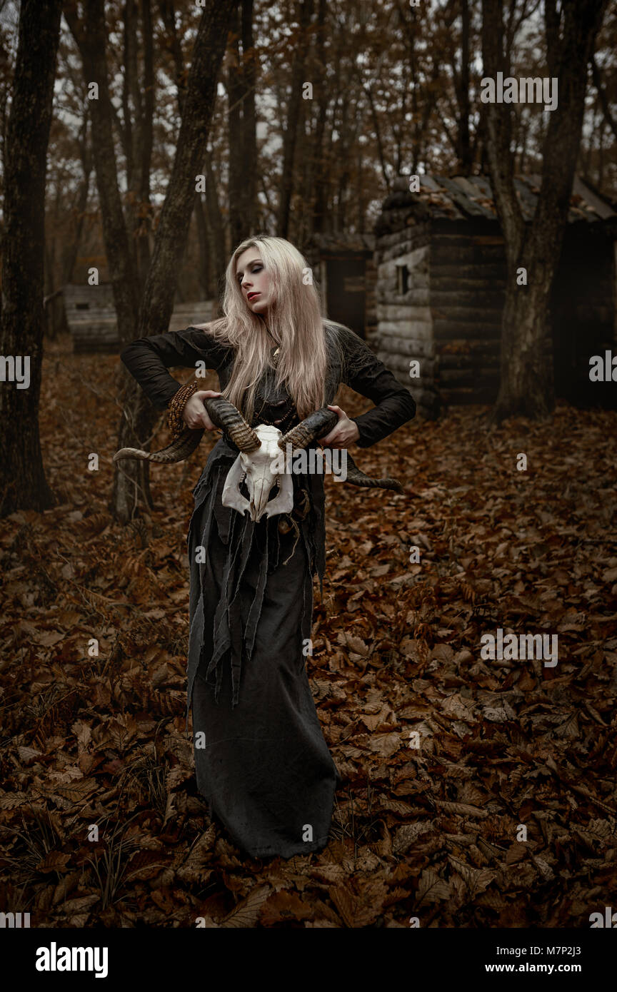 Witch in a long black dress Stock Photo