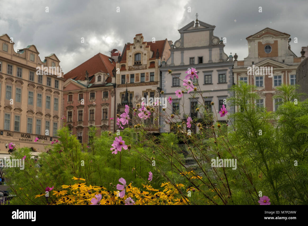 Flowers by Jan Hus Monument and ornate buildings in Old Town Square, Prague Stock Photo