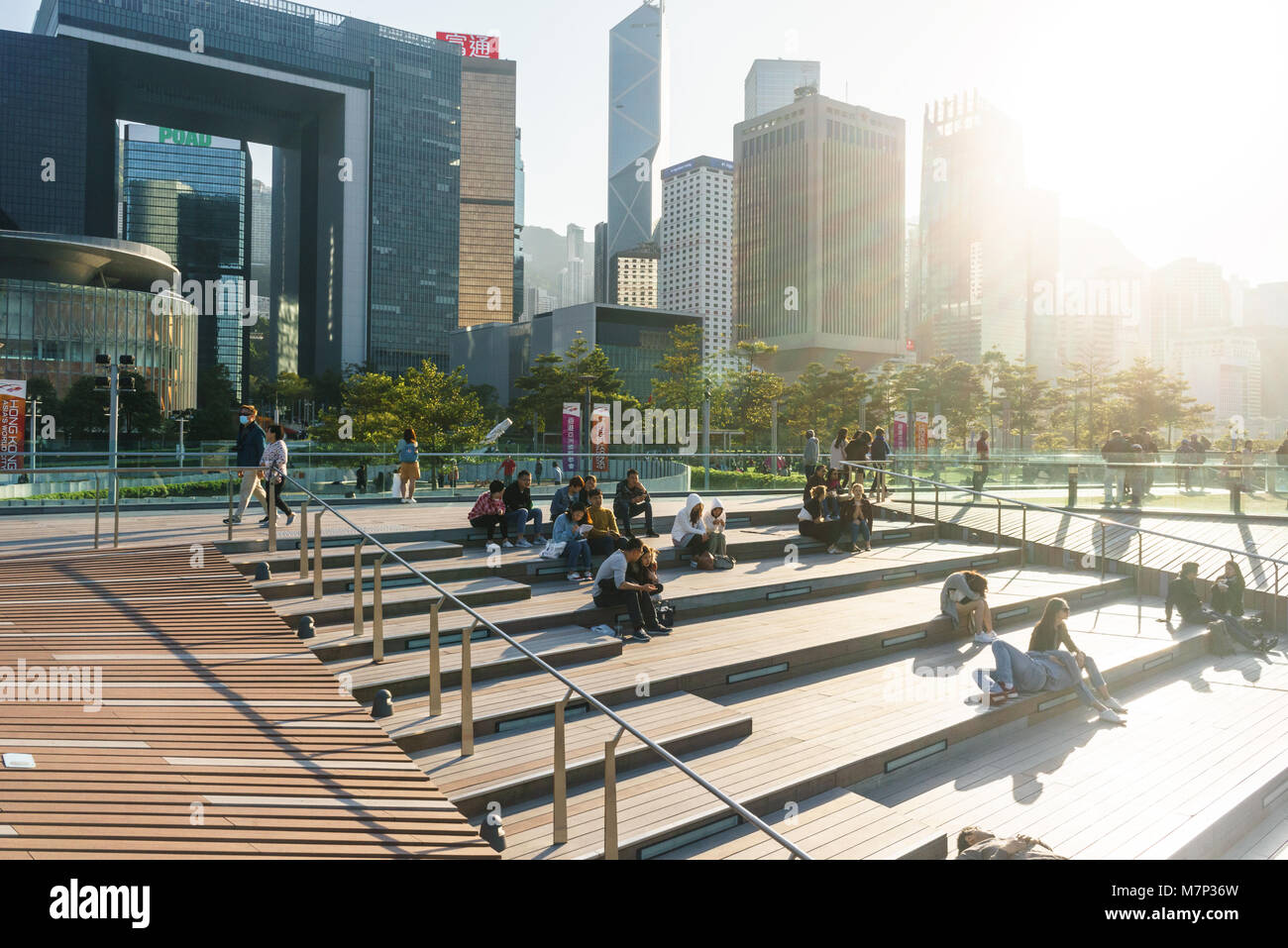 Hong Kong people, residents, enjoying a sunny afternoon at Tamar Park, Admiralty and Central buildings in the background in Hong Kong SAR Stock Photo