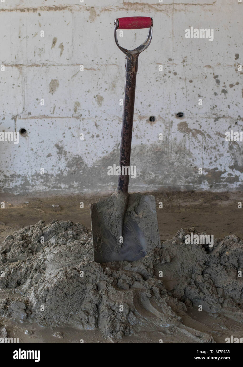 Wet mixed cement and a spade on a building site image in portrait ...