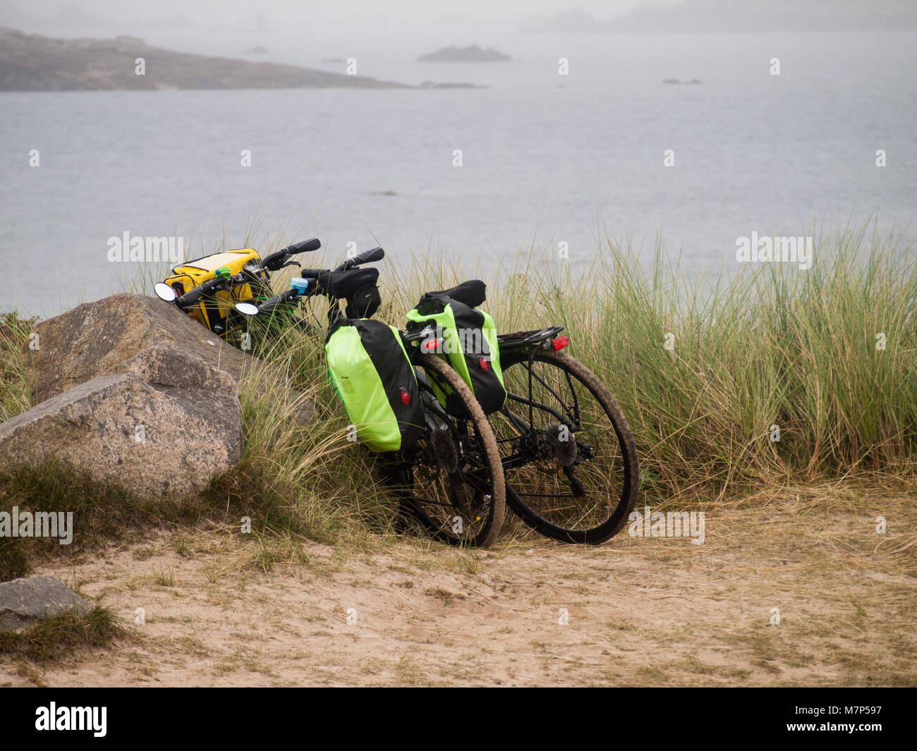 Pennenez. Two touring bikes parked by the sandy beach. Stock Photo