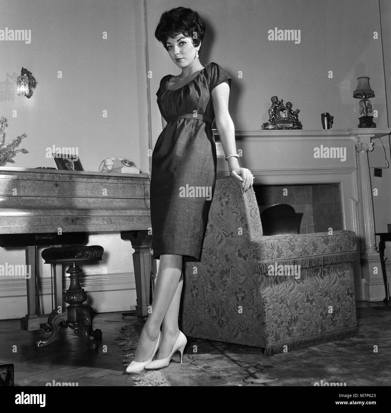 Film star Joan Collins flew into London today from Montego Bay, she is here to spend a few days with her family after which she will fly on to America. She is pictured at her parents flat in Regent's Park.  25th November 1958. Stock Photo