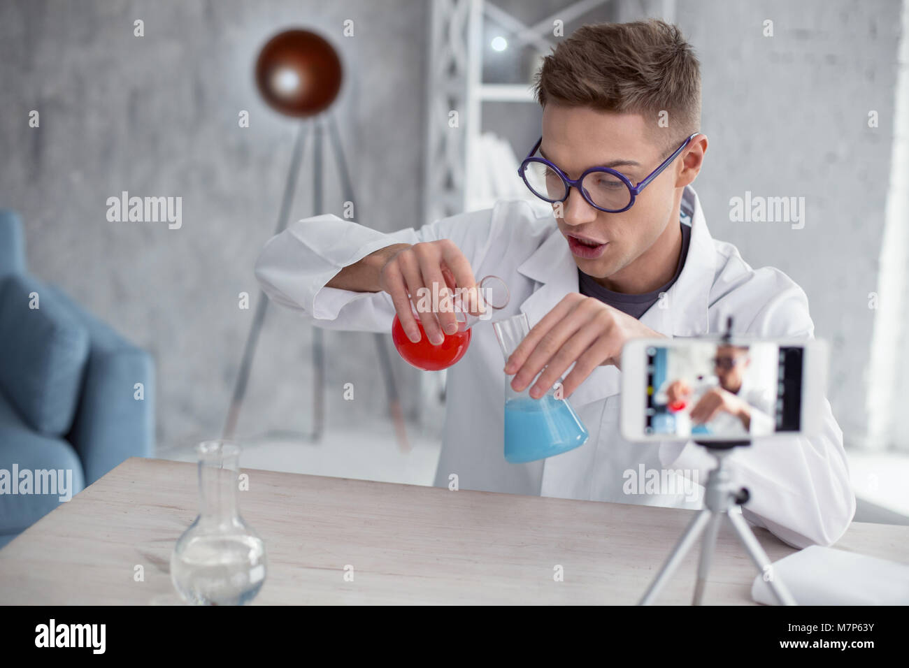 Overwhelmed popular blogger conducting a new experiment Stock Photo