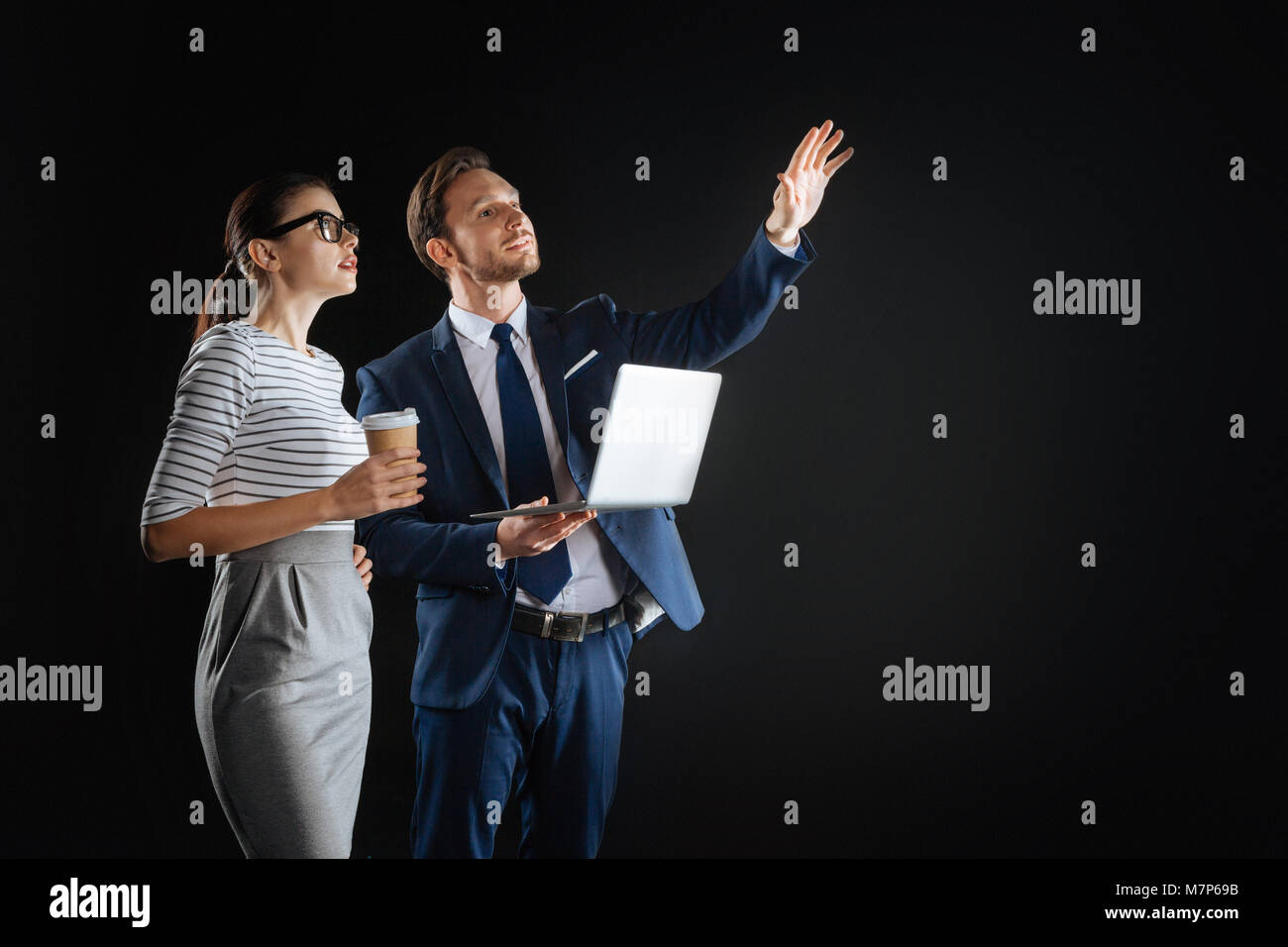 Interested amazed employees standing and looking up. Stock Photo