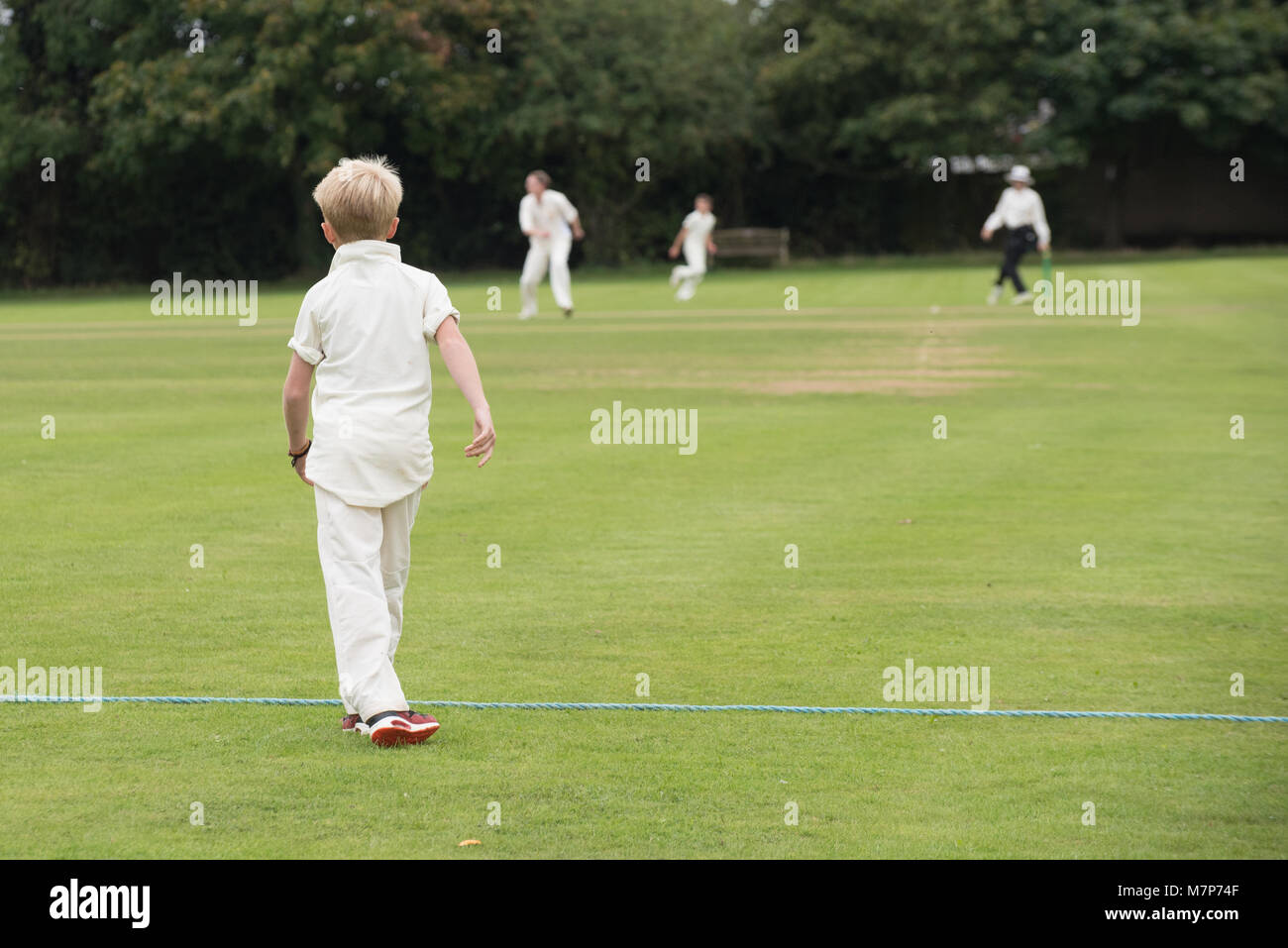 close up of young cricket player warming up before joining the field in a village school youth team Stock Photo