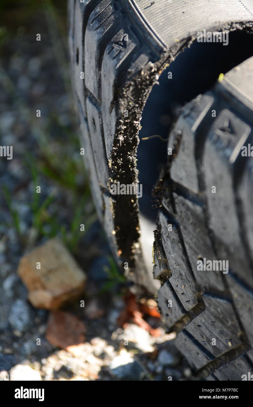 Old tire cut in half in closeup with sun coming through the cut tire Stock Photo