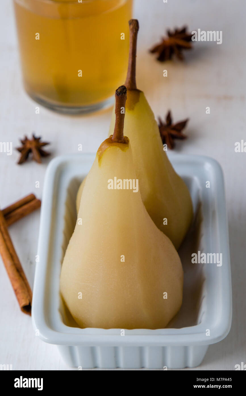 delicious poached golden yellow pears on plate Stock Photo