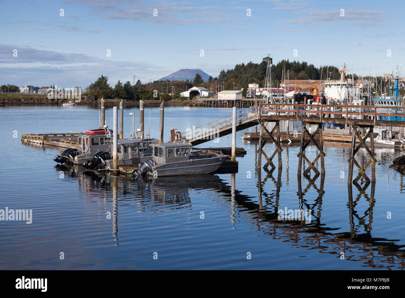 Sitka, Alaska: Fishing boats docked in Sitka Harbor. In the distance is Mount Edgecumbe on neighboring Kruzof Island. Stock Photo