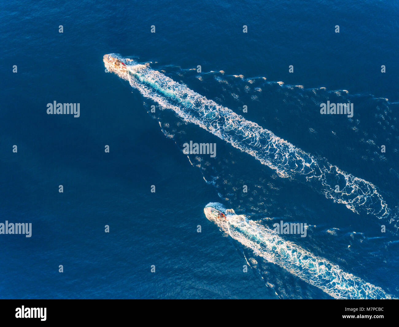 Yacht at the sea. Aerial view of luxury floating ship at sunset. Colorful landscape with boat in marina bay, blue sea. Top view from drone of yacht. L Stock Photo