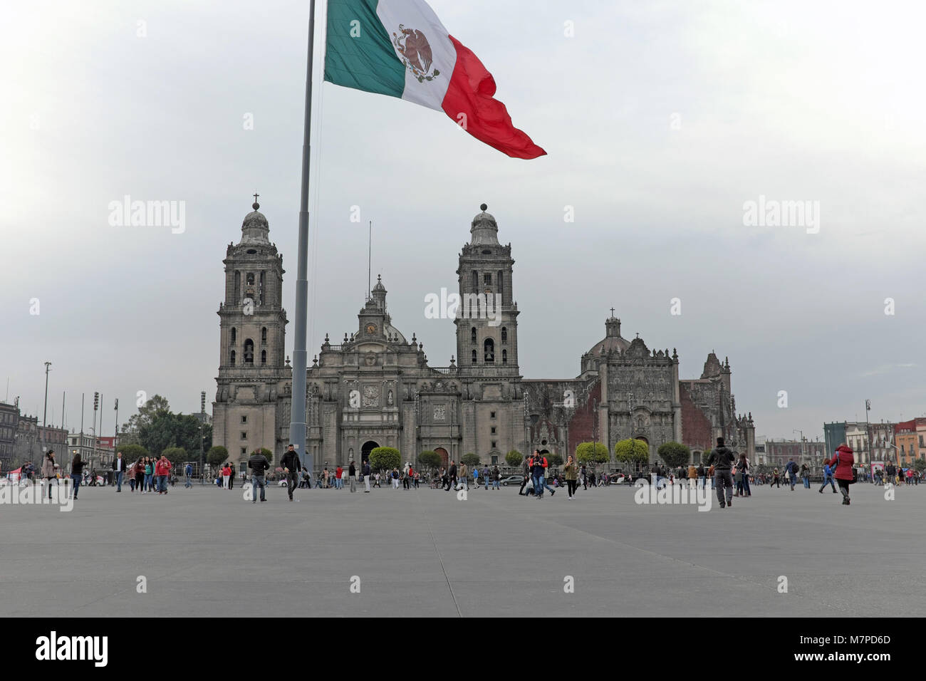 The vast zocalo square in Mexico City holds architectural treasures including the Mexico City Metropolitan Cathedral as shown in the background. Stock Photo