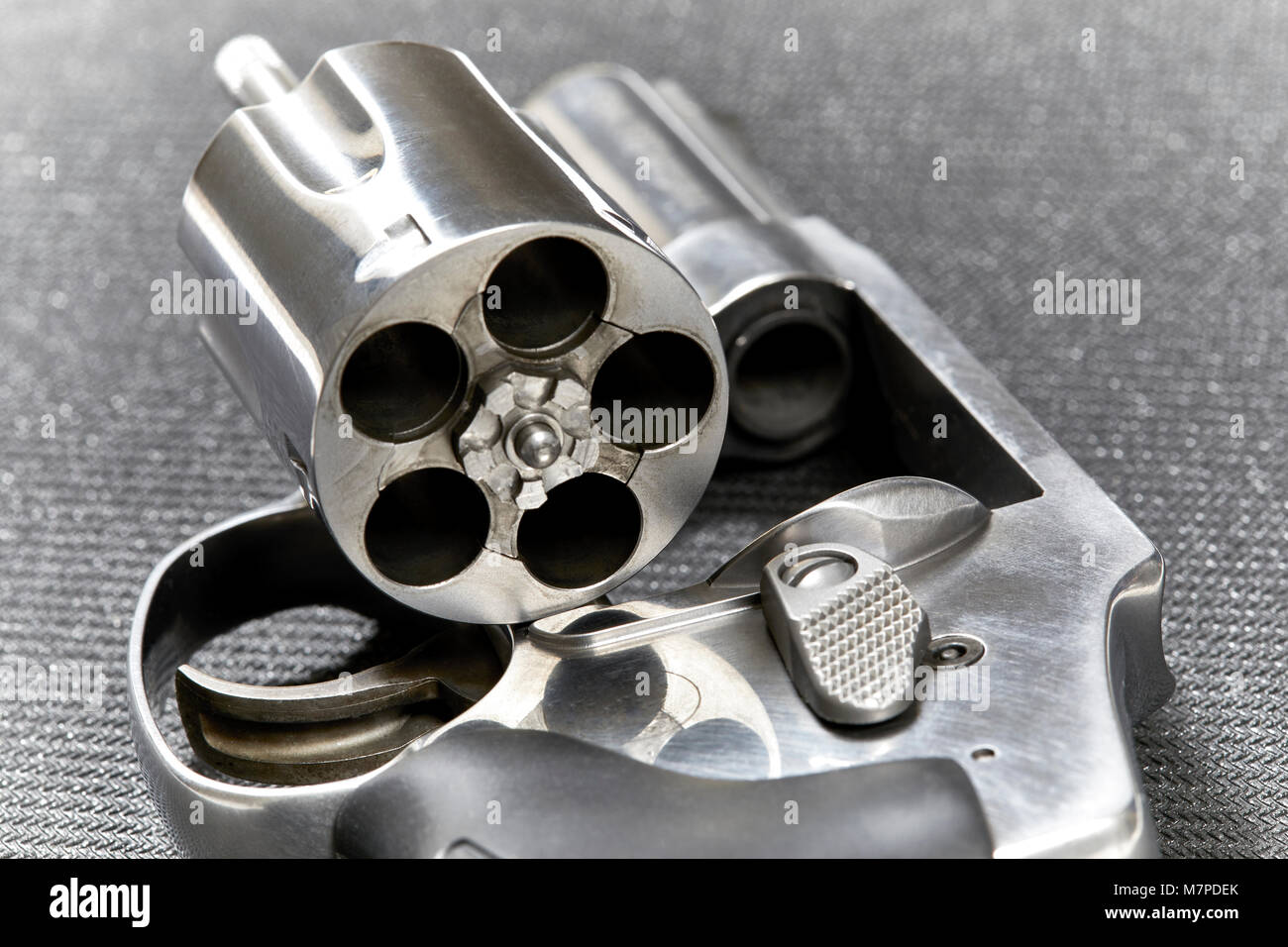 Snubnose revolver with cylinder open isolated on black mat Stock Photo