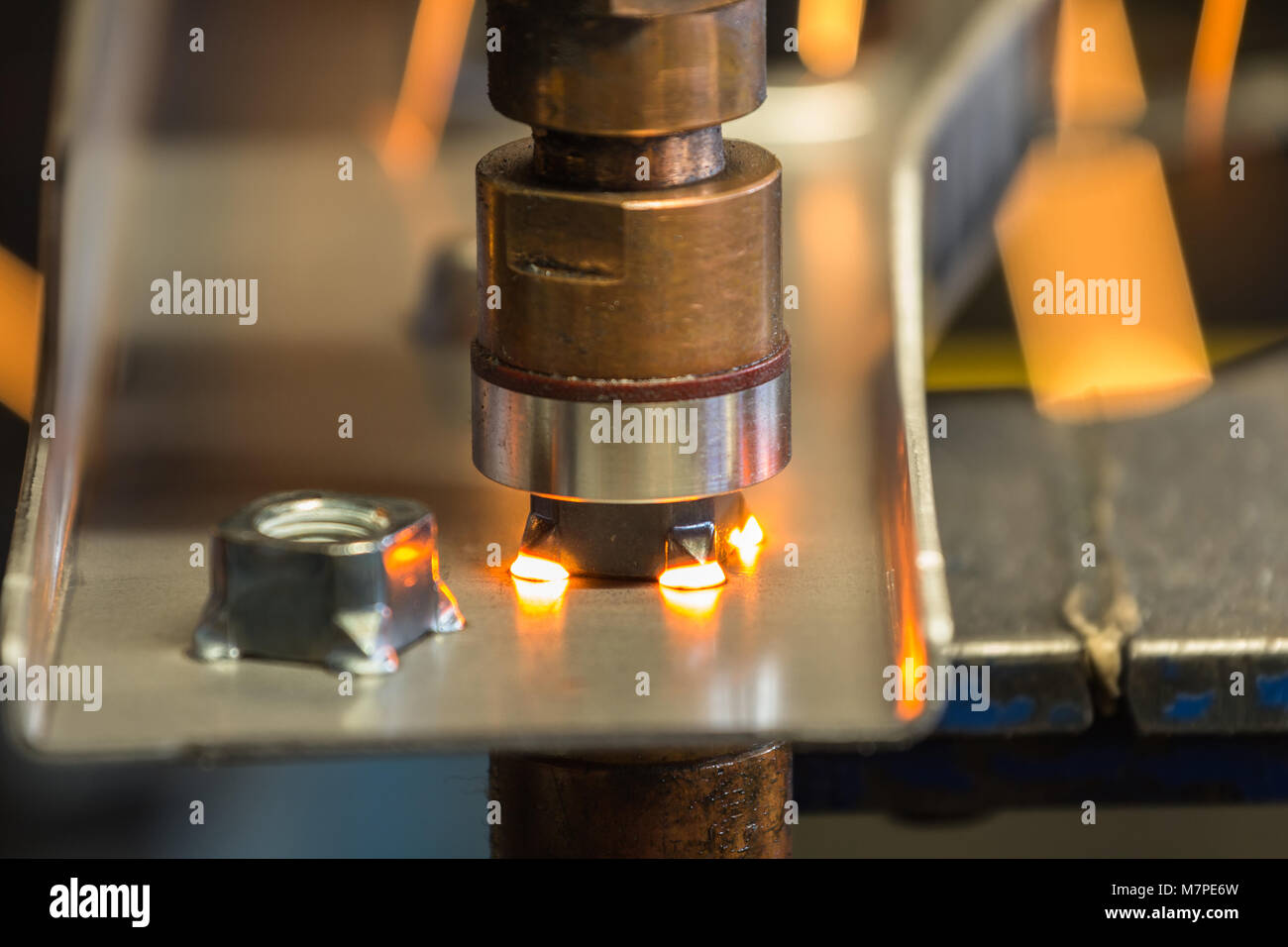 Spot machine is welding nut to automotive part in factory Stock Photo