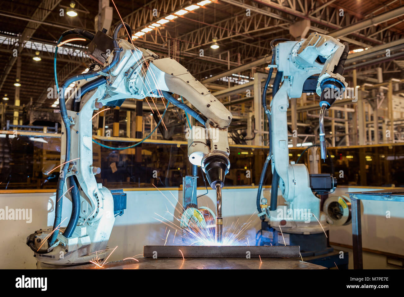 Robots welding in a car factory. Welding car body Stock Photo