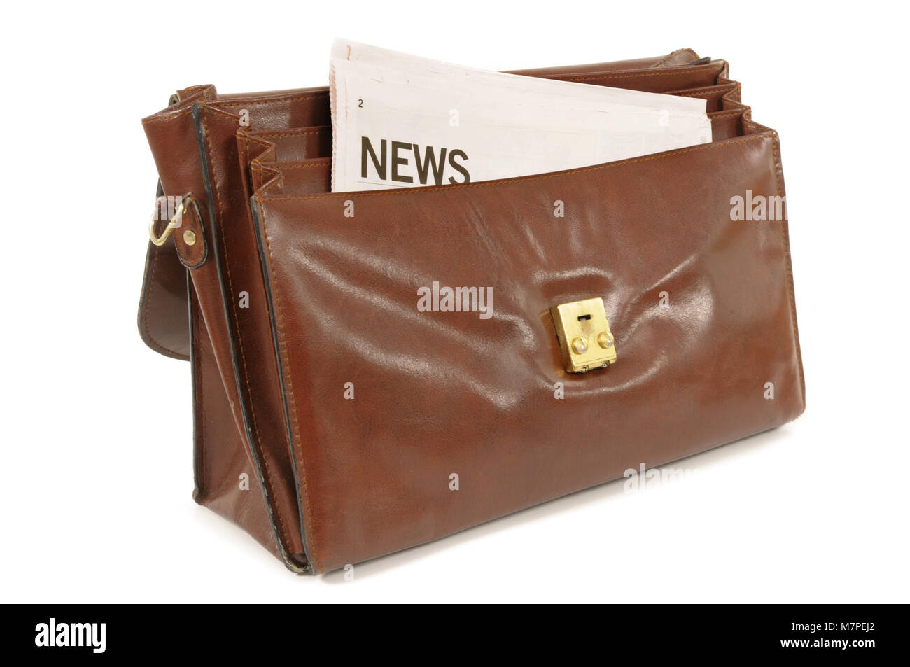 Old leather briefcase with newspaper set against a white background Stock Photo