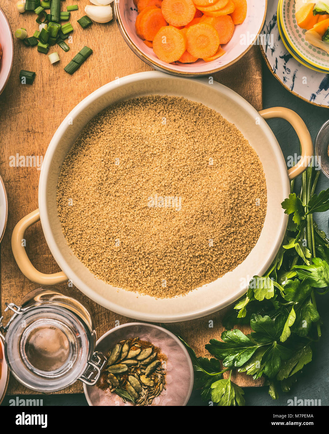 Close up of Couscous bowl and cooking ingredients , top view Stock Photo