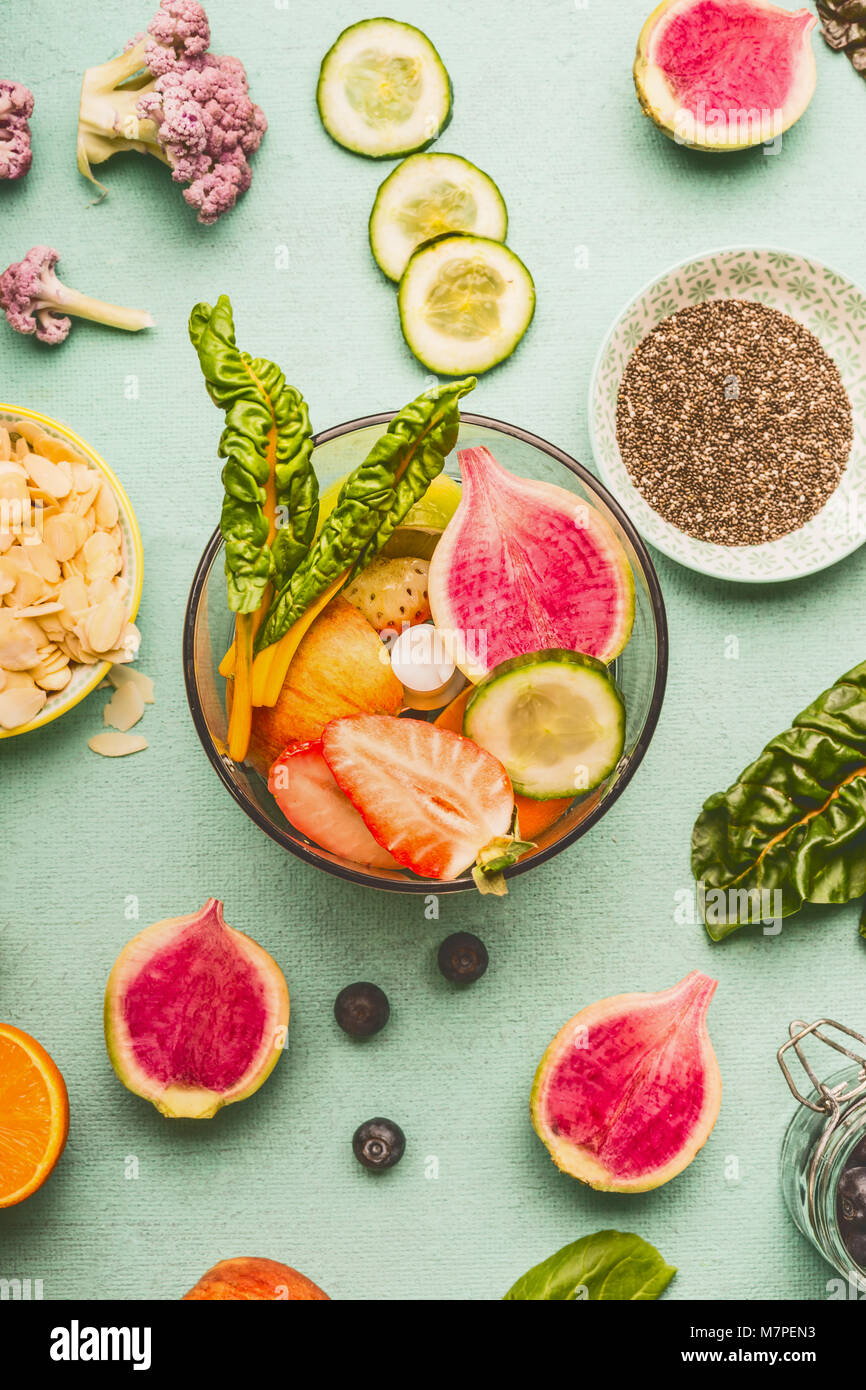 Top view of mixer with various healthy fruits and vegetables