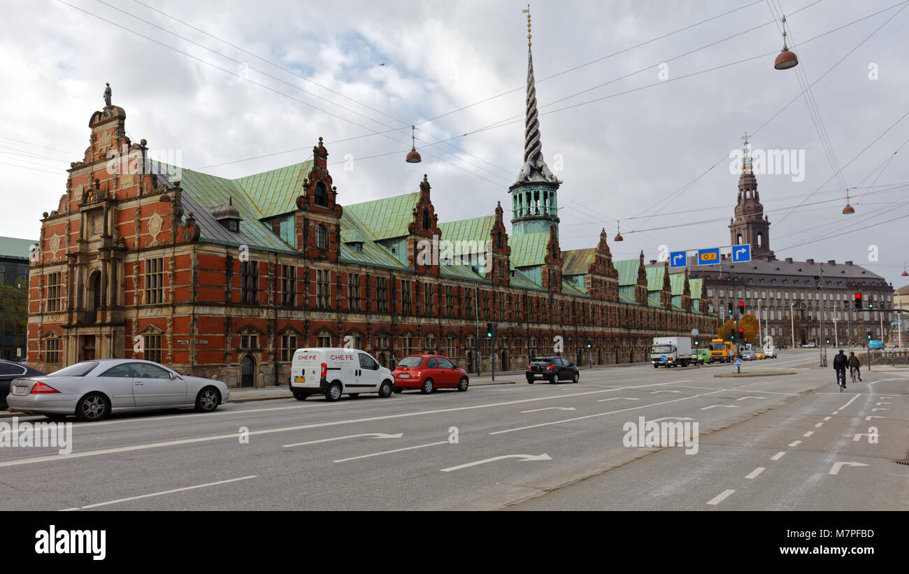 Copenhagen, Denmark - November 7, 2016: Traffic at Borsen building and Christiansborg Palace. The Borsen was built during 1618- 1624 and now is a symb Stock Photo