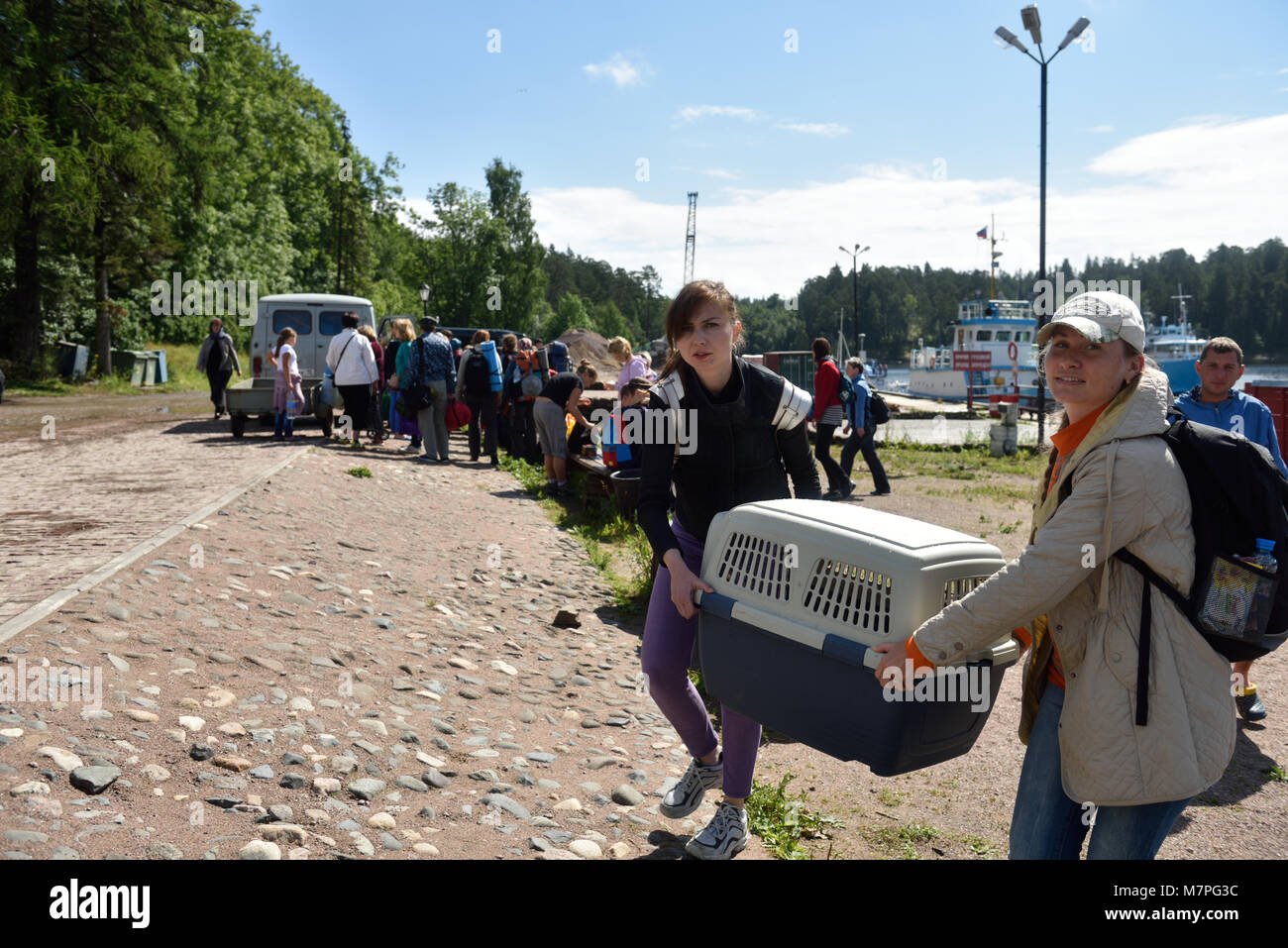 Valaam island, Russia - July 29, 2015: People carrying the cage with Ladoga ringed seal. Animals was cured in the Center of study and conservation of  Stock Photo