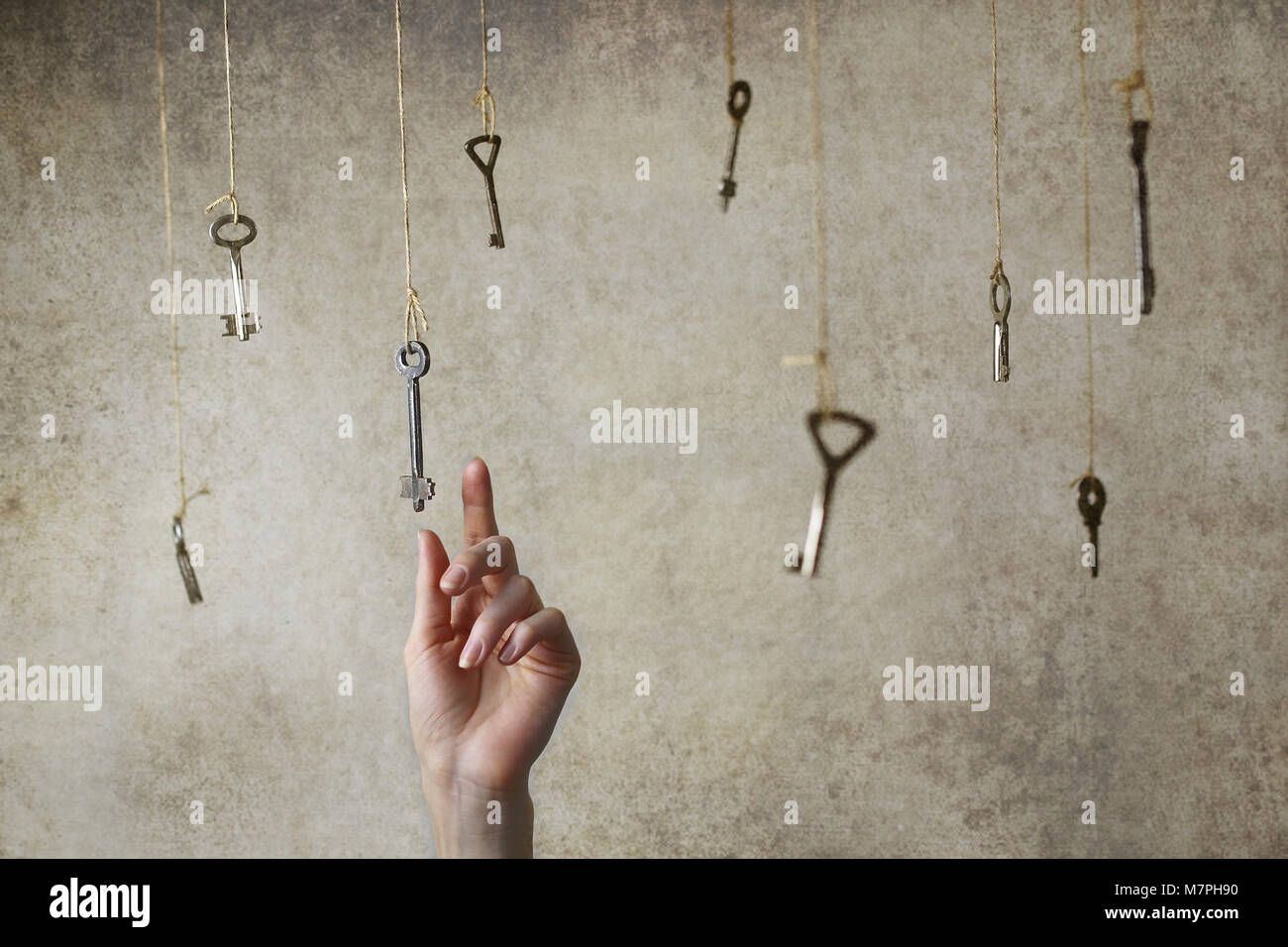 hand stretching for one of the many old vintage keys Stock Photo - Alamy