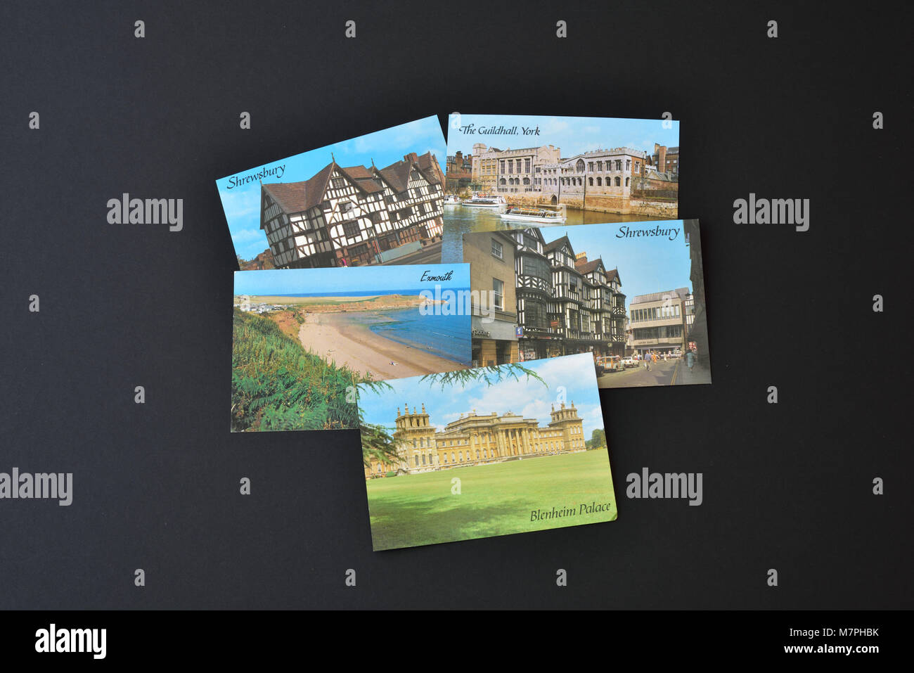 Five J Salmon Ltd postcards depicting English views, shown on a black background. Stock Photo