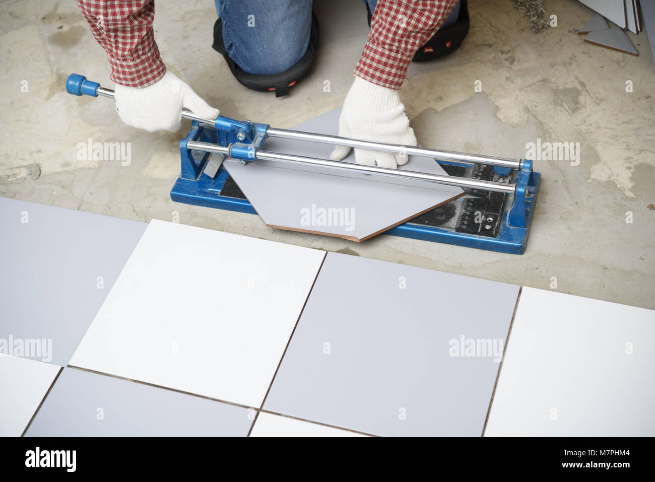 Tiler cutting ceramic tiles during floor installation Stock Photo Alamy