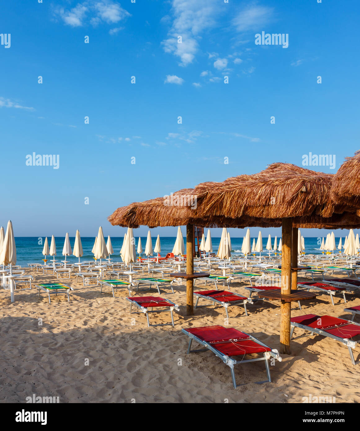 Morning paradise white sandy beach Maldives of Salento with sunshades and sunbeds (Pescoluse, Salento, Puglia, south Italy). The most beautiful sea sa Stock Photo