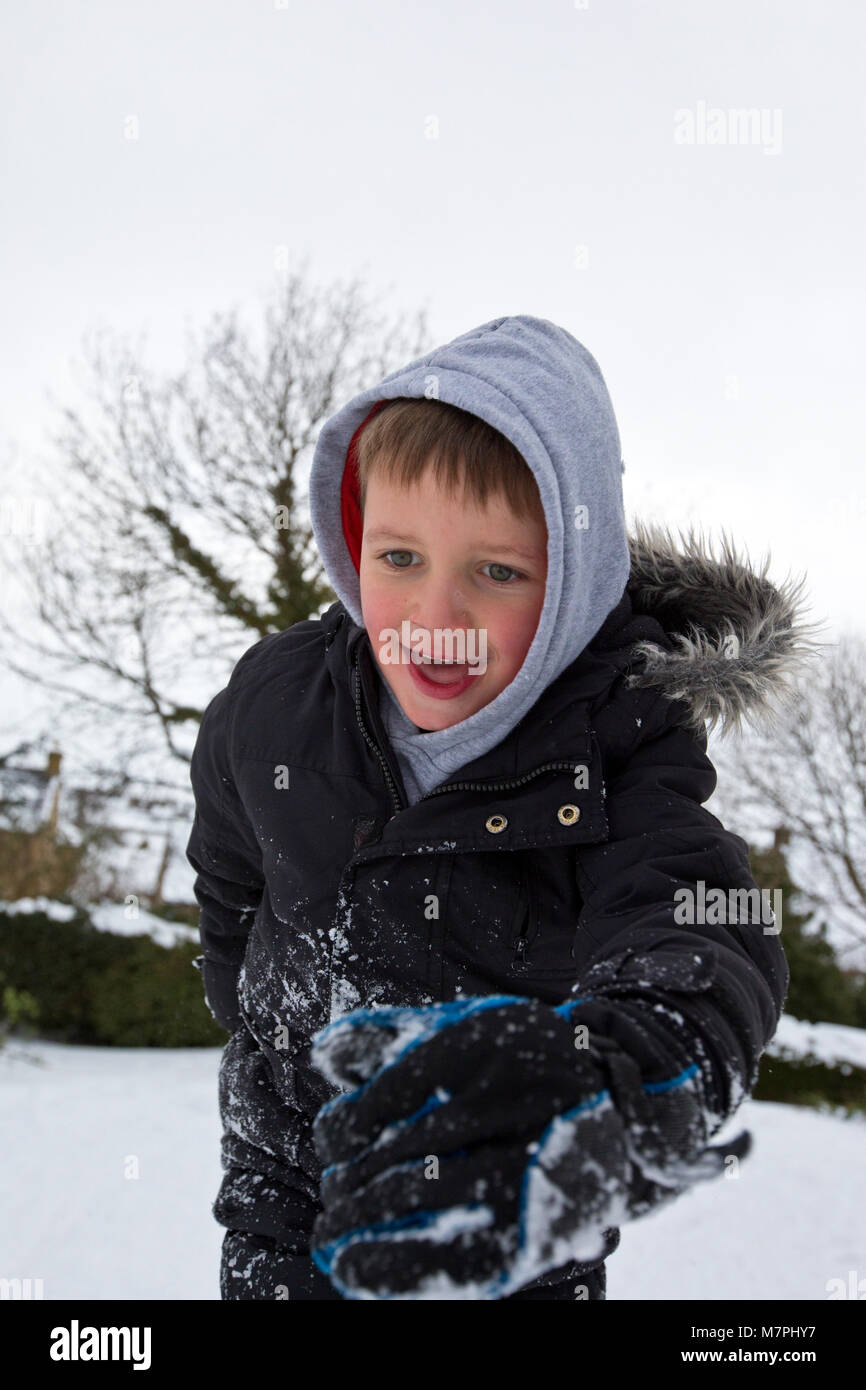 Boy sledging in the snow, UK Stock Photo