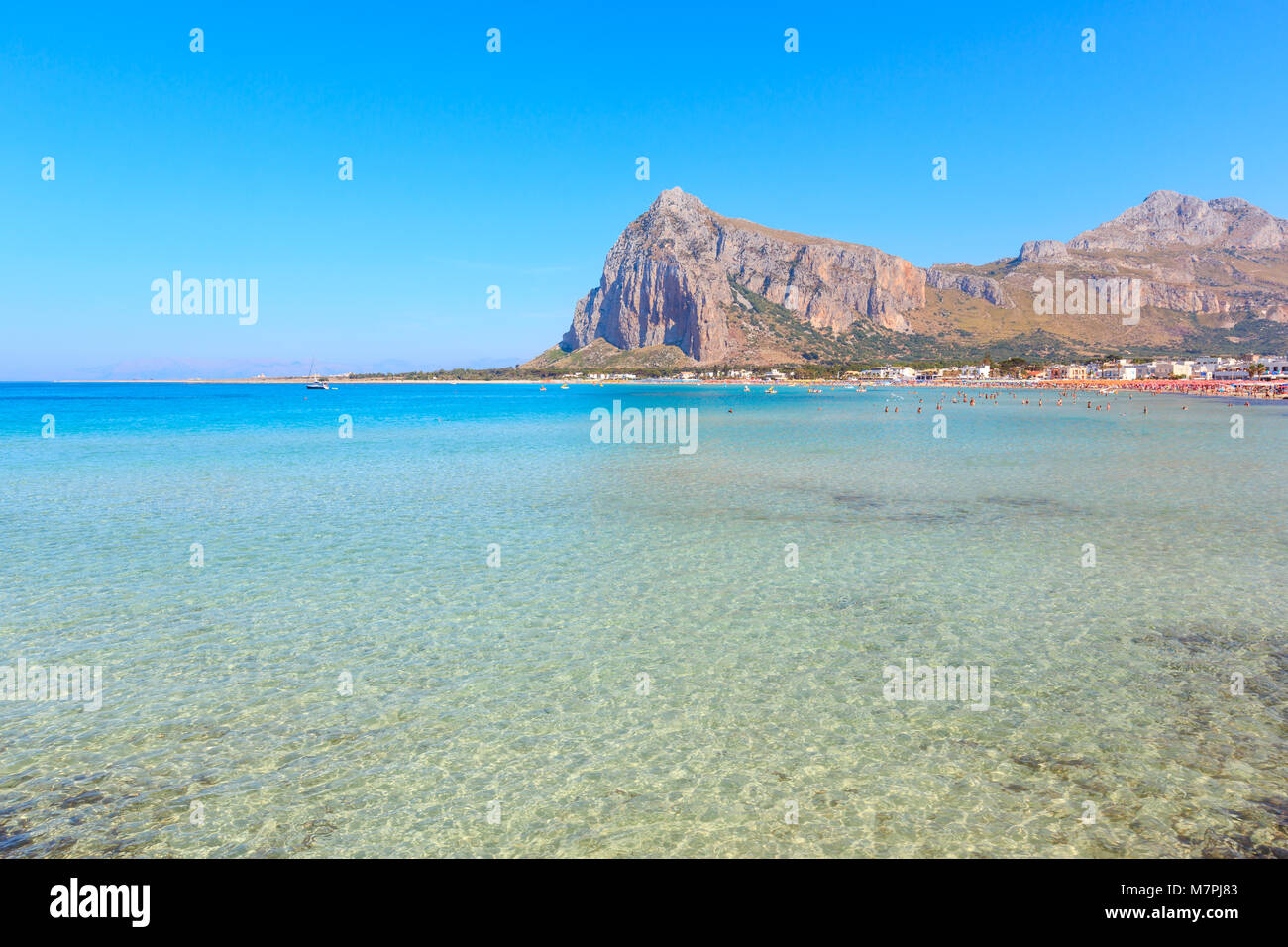 Paradise Tyrrhenian sea bay, San Vito lo Capo beach with clear azure water and extremal white sand, and Monte Monaco in far, Sicily, Italy. People unr Stock Photo