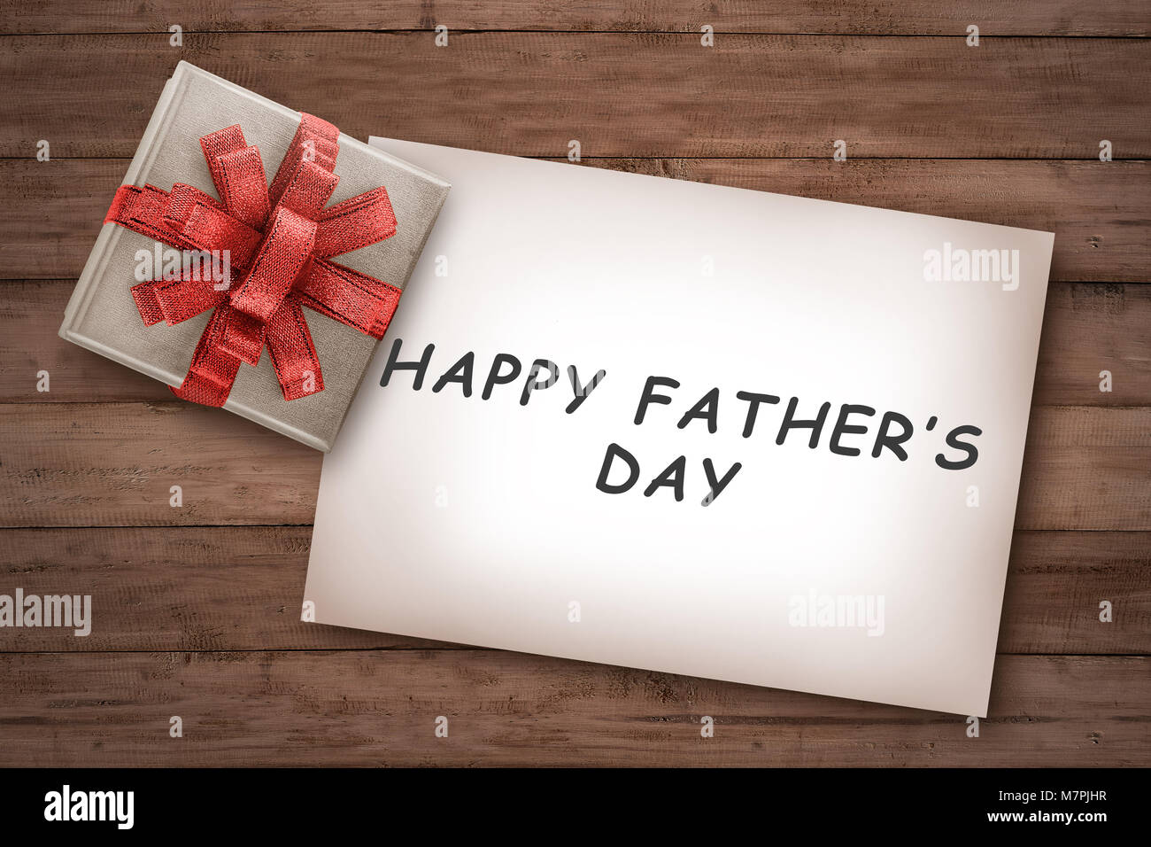 Happy fathers day messages on paper with gift on the wooden background. Fathers day concept Stock Photo