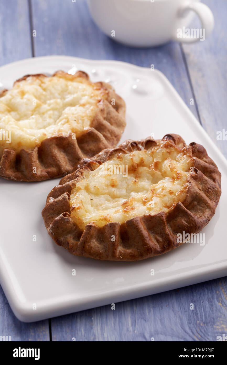 Karelian pasty with rice on a rustic table Stock Photo