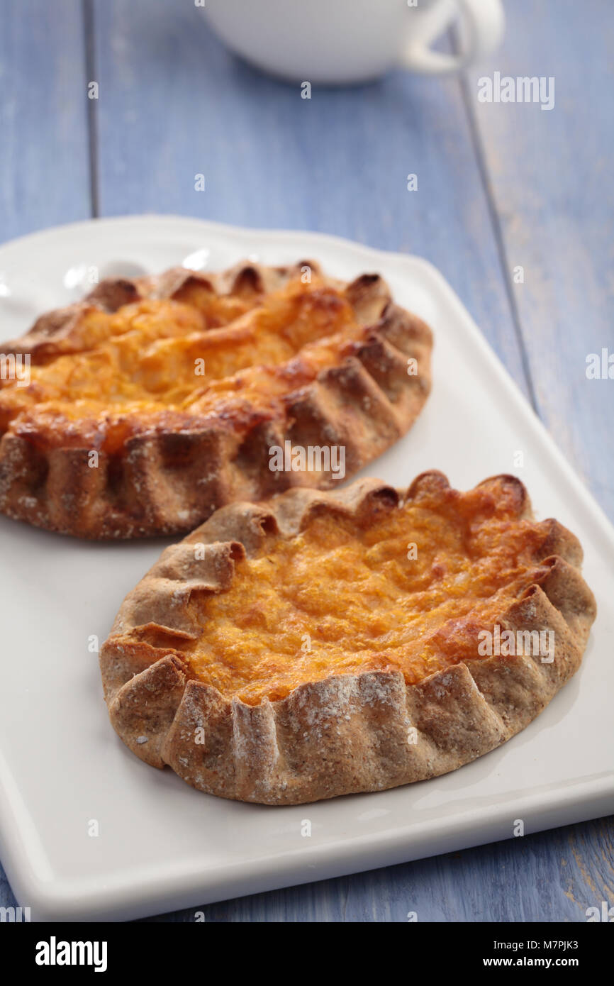 Karelian pasty with carrot on a rustic table Stock Photo