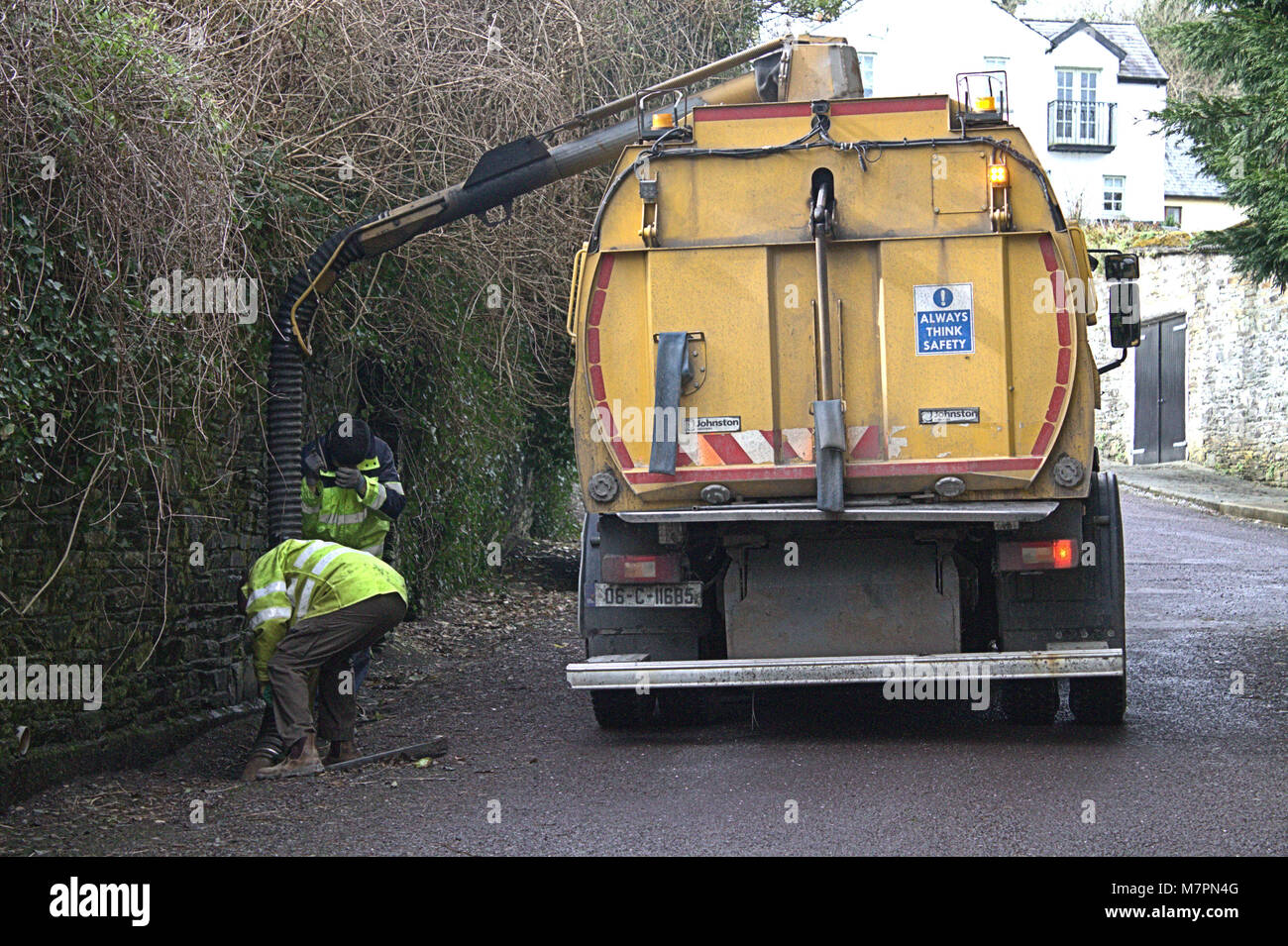 council workmen clearing blocked road drains in Castletownshend, West Cork, Ireland Stock Photo